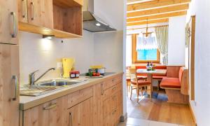 a kitchen with a sink and a dining room at Roderhof in Braies