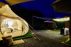 a tent is set up in a yard at night at Lotus Glamping in Tiszalök