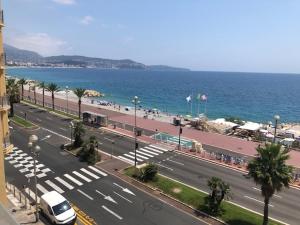 a view of a city with a street and the ocean at EROS in Nice