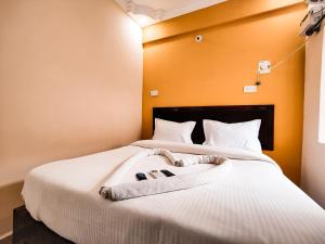 a bedroom with a bed with two towels on it at Hotel Candolim Aloft in Candolim