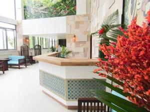 a lobby with a sink and flowers on the wall at HAYA Sea View Hotel Phu Quoc in Phu Quoc