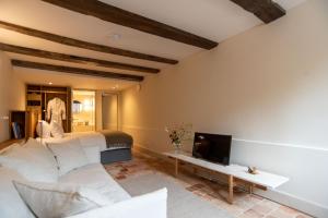 a bedroom with a white bed and a tv at de Bloemgracht in Amsterdam