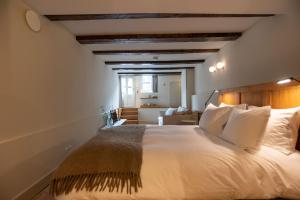 a bedroom with a large bed with white pillows at de Bloemgracht in Amsterdam