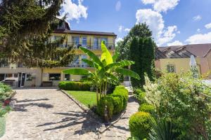 a garden in front of a yellow building at Hotel Naslada in Balchik