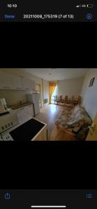 a kitchen and living room with a bed in a room at Family apartment on the skiing slope in Allevard