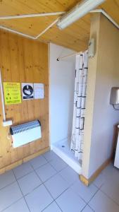 a room with a bathroom with a shower and a window at Glamping-Dimbo in Krynica Zdrój