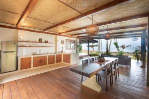 a kitchen with a table and a dining room at Rare Beachfront Villa - 2BR - 6 Pax Private Pool on Tuason Surf Spot in General Luna