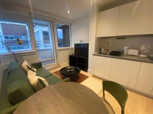a living room with a couch and a table at 90s RETRO 1Bed Studio Apartment Wembley Park London Private GYM & CINEMA & Netflix Perfect for Solo & Coupled Travellers in London