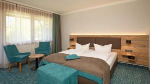 Voodi või voodid majutusasutuse Das Wiesgauer - Alpenhotel Inzell toas