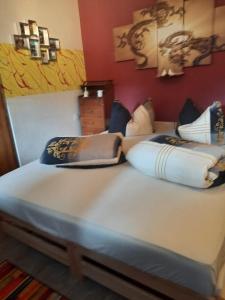 a bed with pillows on it in a room at Home&Classic - Alte Werkstatt in Effelder