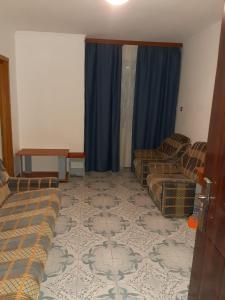 a living room with a couch and chairs and a table at Vila Margaritar in Eforie Sud