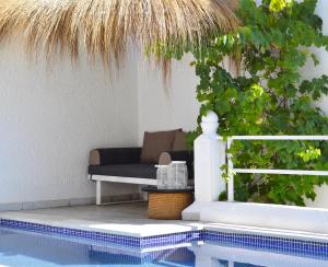 a swimming pool with a couch next to a house at VILLA EDO in Gammarth