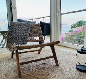 a wicker chair in a living room with a window at Myflats Villa Sea Cove in El Campello