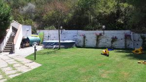 a backyard with a fence and a yard with a toy car at CILENTO CASE&VACANZE - Villa Leyland in Laureana Cilento