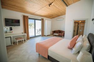 a bedroom with a bed and a living room at Ali Baba Ciftligi Boutique Hotel in Alacati