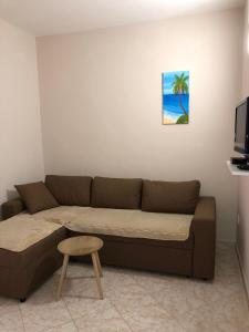 a living room with a brown couch and a table at Apartments Ela in Ulcinj