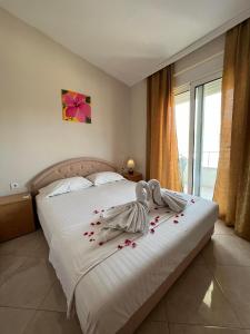 a bedroom with a bed with flowers on it at Apartments Ela in Ulcinj