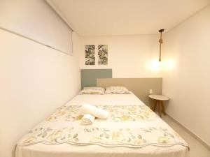 a small bedroom with a bed with aroll at Praia dos Carneiros Flat 206 C in Tamandaré +34 photos