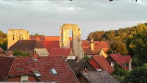 Blick auf eine Stadt mit Dächern und ein Schloss in der Unterkunft Klosterhotel Walkenried in Walkenried