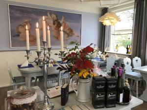 a dining room with a table with candles on it at Klosterhotel Walkenried in Walkenried +51 photos