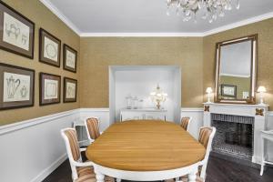 a dining room with a table and a fireplace at Pand 17 - Charming Guesthouse in Bruges +26 photos