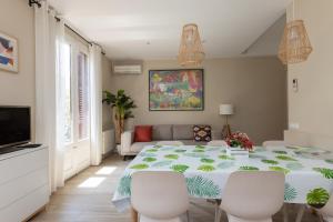 comedor con mesa grande y sillas blancas en ApartEasy - Family 4-Bedroom Apartment en Barcelona