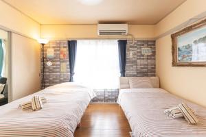 A bed or beds in a room at 汐の香 - shio no kaori