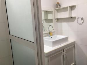 a bathroom with a white sink and a mirror at Sabina villa in Pereybere +35 photos