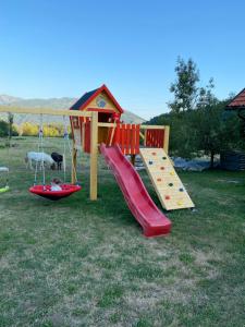 a playground with a slide and a play structure at Apartment Bandaron in Kobarid