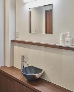 a bathroom with a bowl sink on a counter at 京都駅前ひふみ旅館（HifumiRyokan Kyoto station) in Kyoto