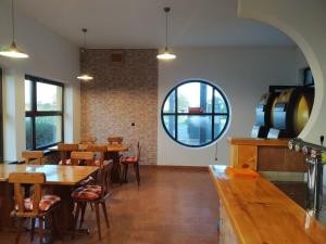 a restaurant with tables and chairs and a large window at LEO - PENZION in Jevišovice