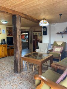 ein Wohnzimmer mit einem Tisch und einigen Stühlen in der Unterkunft Casa Rural La Mansion in La Toba