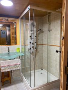 a bathroom with a glass shower with a sink at Casa Rural La Mansion in La Toba