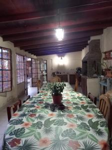 a dining room with a table with a plant on it at La casita de abu! in Salta