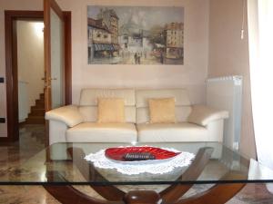 a living room with a couch and a glass table at The quiet corner in Noale +13 photos