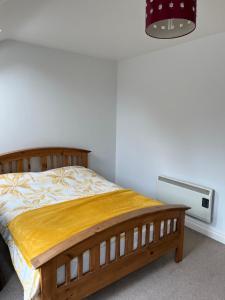a bedroom with a wooden bed and a heater at The Beach House in Lahinch
