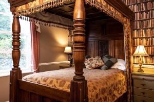 a canopy bed in a bedroom with a window at Lonsdale House in Windermere