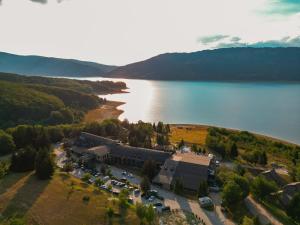 an aerial view of a building next to a lake at Hotel Radika in Mavrovo