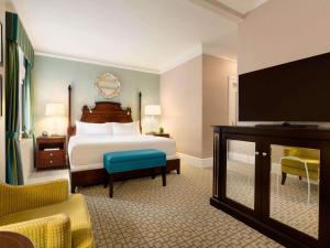 a hotel room with a bed and a flat screen tv at Fairmont Chateau Laurier in Ottawa