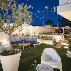 a garden with a toilet and a hammock and a tree at Hotel Riviera in Bari