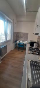 a kitchen with a stove and a table in it at Casa Felix Ostia in Lido di Ostia