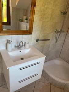 a bathroom with a sink and a shower at Gościniec Zośka in Ostrzyce