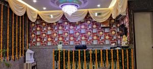 a stage with a curtain and a chandelier at Hotel The Best Relax Inn By WB Inn in New Delhi