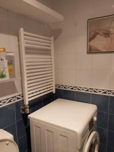 a small bathroom with a white refrigerator and a window at Vivienda próxima a la puerta del sol Vigo in Vigo