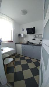 a kitchen with a checkered floor at Seaside in Gdańsk