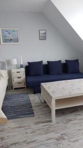 a living room with a blue couch and a table at Seaside in Gdańsk +11 photos