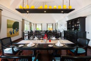 a dining room table with two chairs and a table cloth at InterContinental Koh Samui Resort, an IHG Hotel - SHA Extra Plus in Taling Ngam Beach