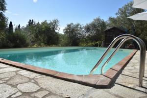 a swimming pool with a slide in a yard at Podere Borgaruccio in Peccioli