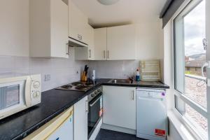 a kitchen with white appliances and a window at Destiny Student &ndash; Murano (Campus Accommodation) in Edinburgh