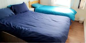 a bed with blue sheets in a bedroom at The Osprey Hotel in Blackpool